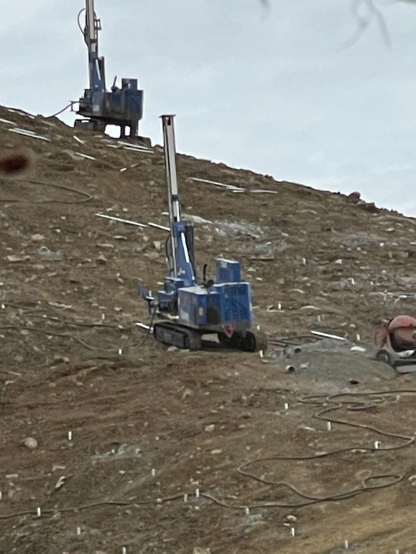 AGL-460G geothermal drill rig performing vertical drilling on hillside